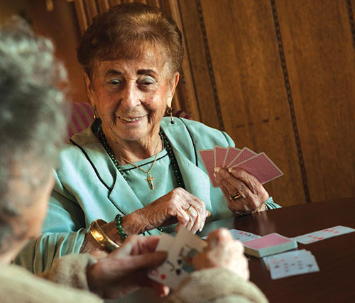 Two elderly woman playing cards